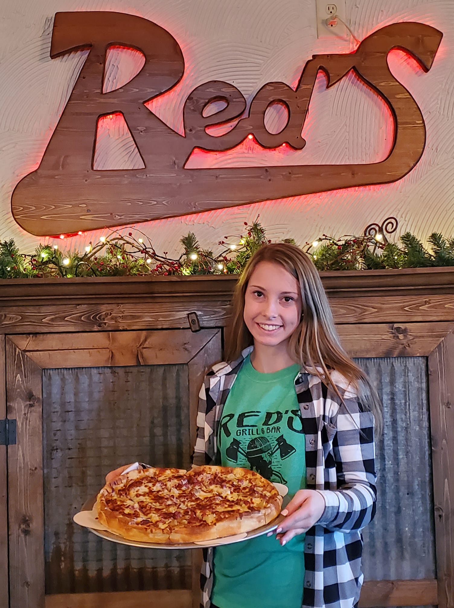 Ashley holding pizza